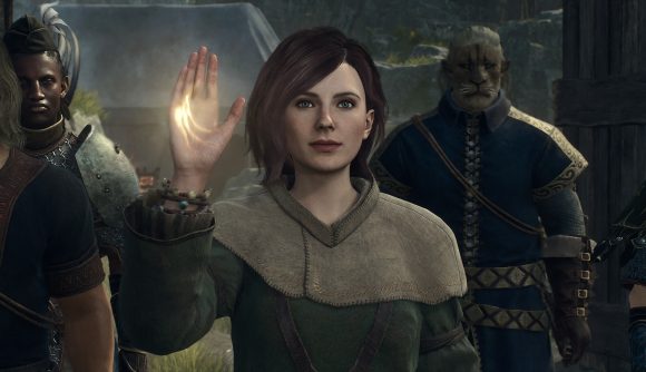 Image of red-haired women in traveling clothes raising her right hand to show a glowing scar on it.