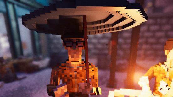 A close-up of a man in an umbrella, near a fire.